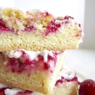 Raspberries and Cream Bars have a sweet chewy crust, creamy cheesecake filling, and are topped with a sweet cream glaze! Perfect potluck and party recipe.