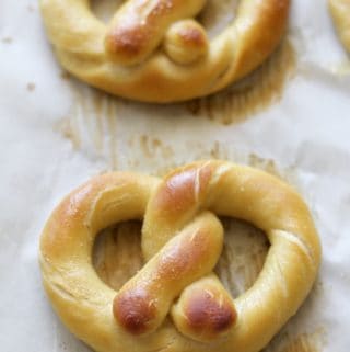Baked Pretzels in a pan on parchment paper.
