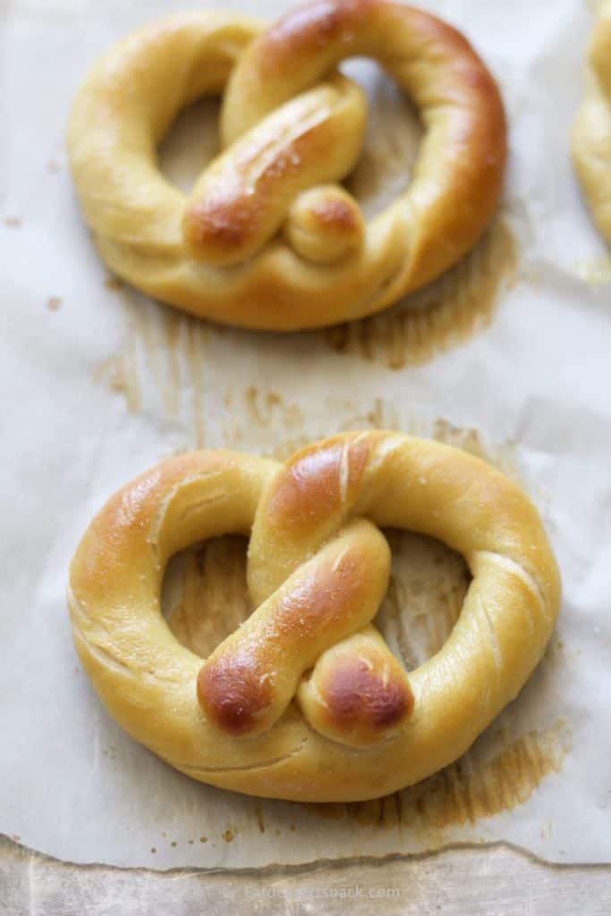 Baked Pretzels in a pan on parchment paper. 