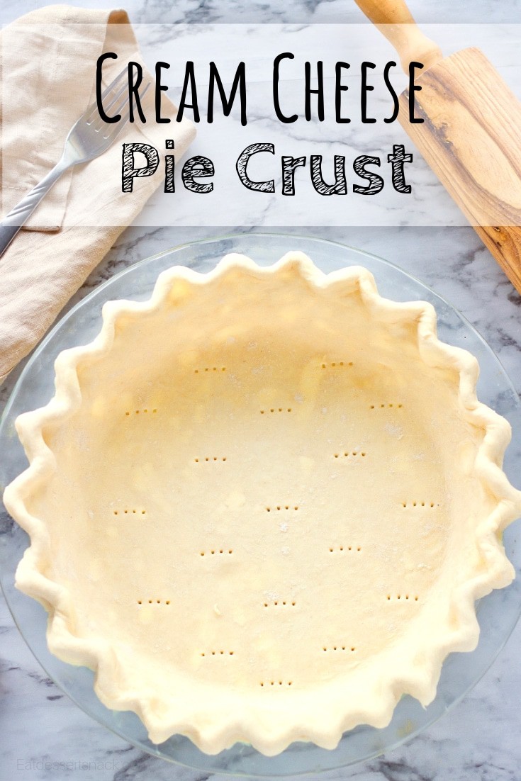 Raw Cream cheese pie crust in a glass pan with rolling pin.
