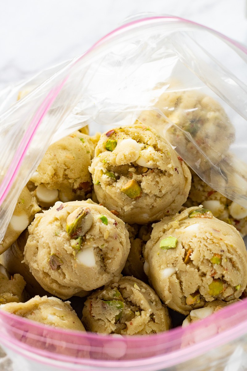 Raw pistachio pudding cookie dough balls in a freezer bag. 