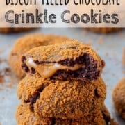 Stack of baked biscoff filled chocolate cookies on a pan.