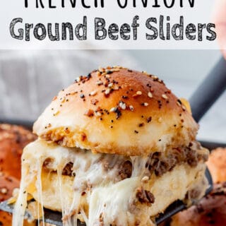 Cooked slider lifting out of a pan with melted cheese pulling down.