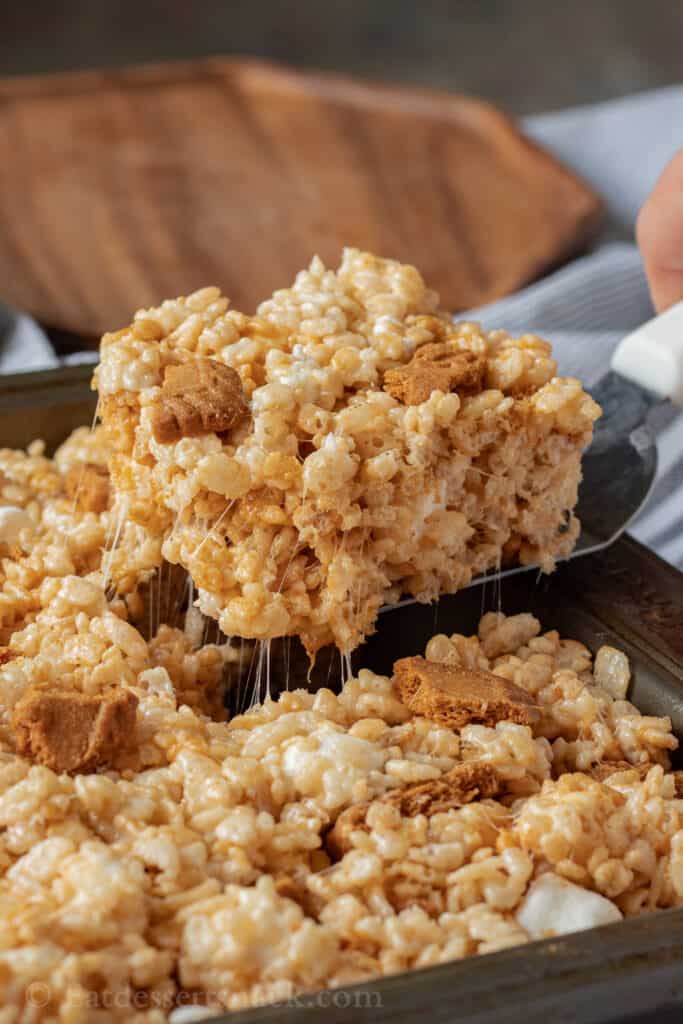 spatula with slice of cookie butter rice krispie treat and gooey marshmallow.