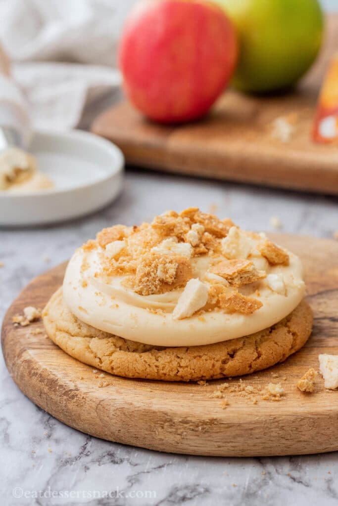 Baked caramel apple cookie on wood cutting board. 