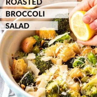 Cooked broccoli salad in blue bowl with lemon, text overlay reads "easy roasted broccoli salad".