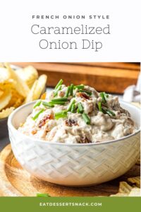 White textured bowl filled with caramelized onion dip on wood board with chips.