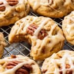 Baked Maple Cookies on metal pan with bite out of one.