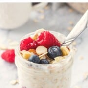 Jar of vanilla overnight oats with metal spoon.
