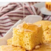 Pouring honey on top of honey butter cornbread slices.