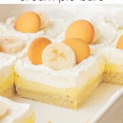 Slices of banana cream pie bars in ceramic pan.
