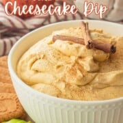 Bowl of pumpkin cream cheese dip in white bowl with cinnamon sticks.