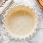 Raw cream cheese pie crust in glass pan