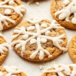 Baked iced molasses cookies on baking sheet.