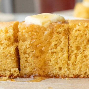 Drizzling honey over buttered cornbread slices.