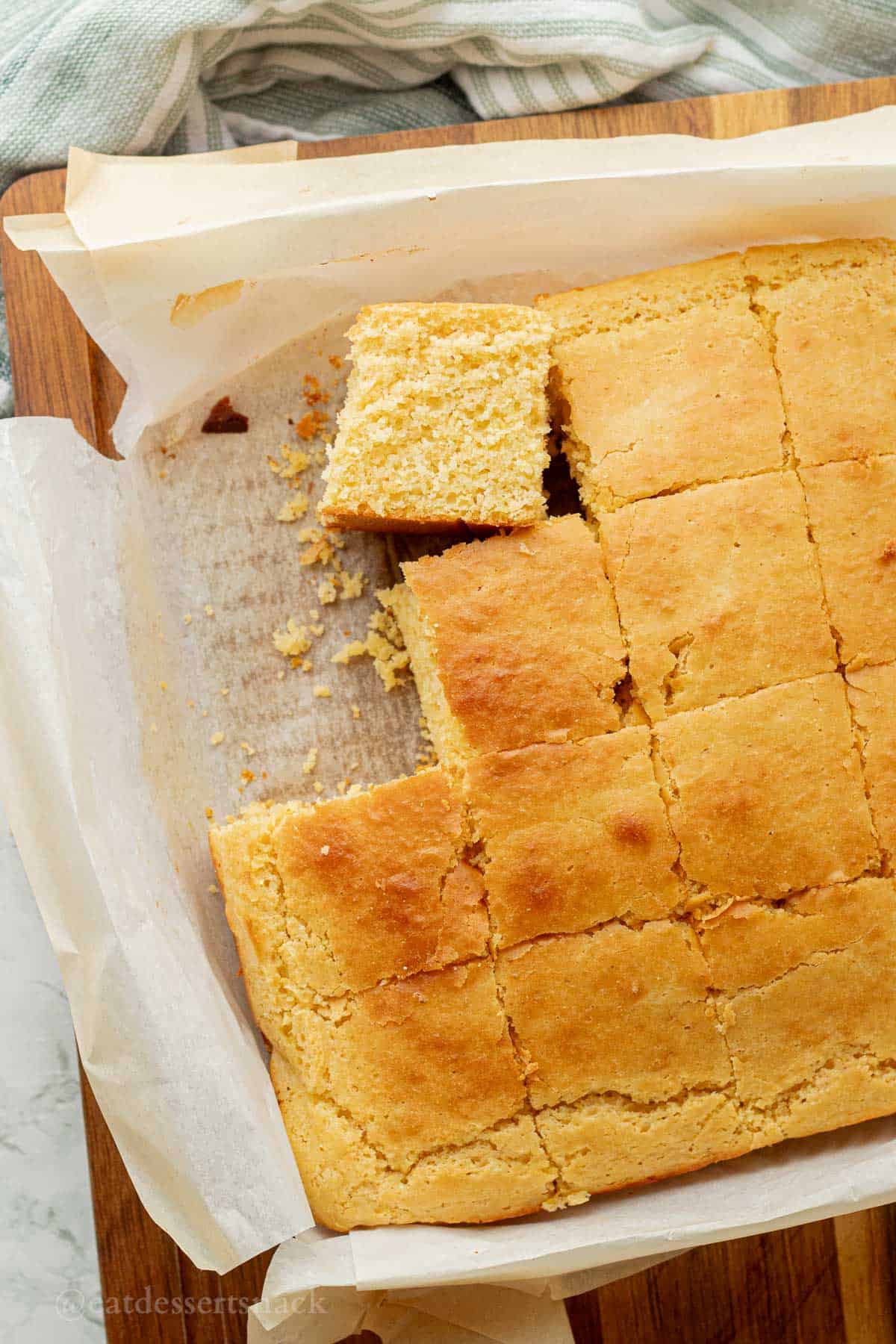 Sliced discard cornbread on parchment paper.