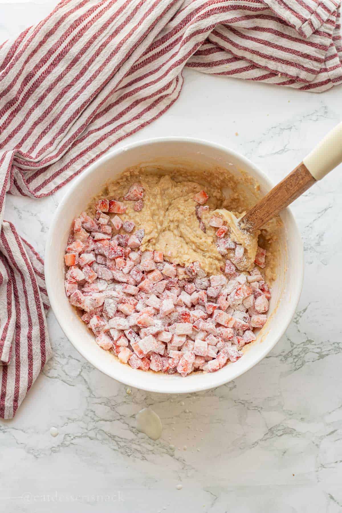 Flour tossed strawberries in raw banana bread batter.