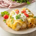 Baked green chile enchiladas on a plate.