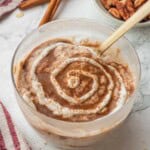 Swirl of greek yogurt on cinnamon roll overnight oats.