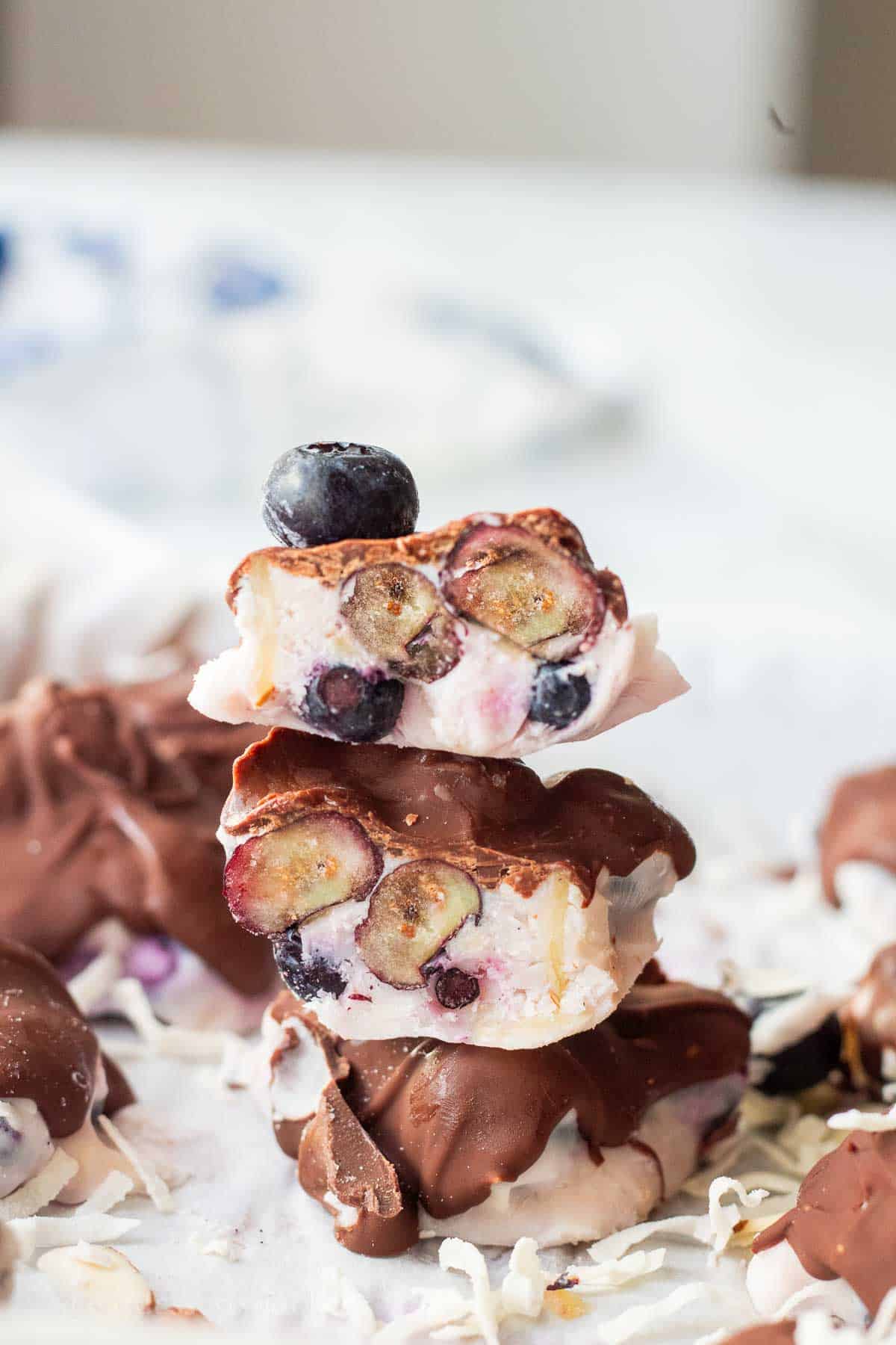 Hardened chocolate on blueberry yogurt clusters cut in half.