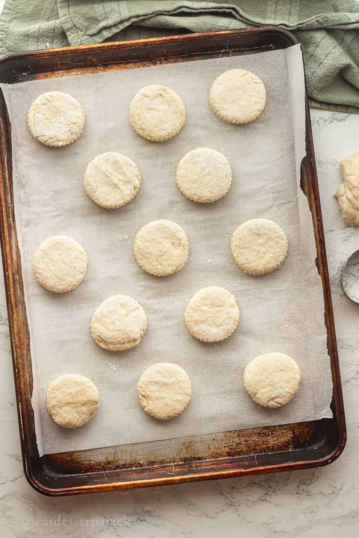 Raw biscuits on baking sheet.