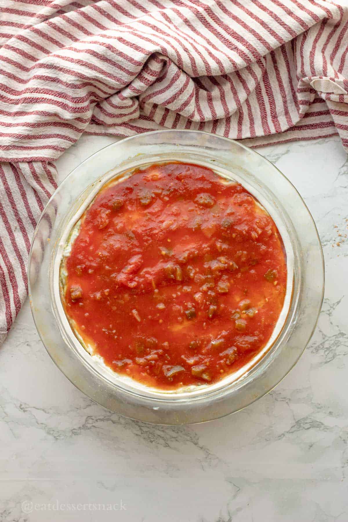 Salsa on top of layers in pie pan.