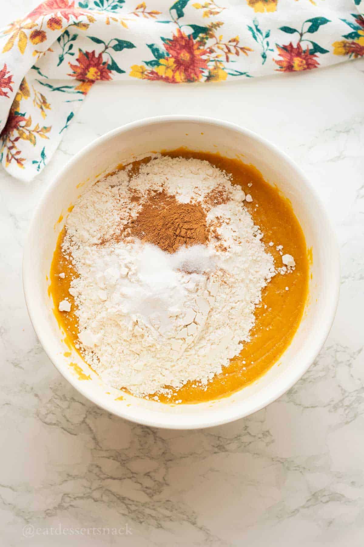 Cinnamon, flour, salt, and baking soda on top of pumpkin mixture.