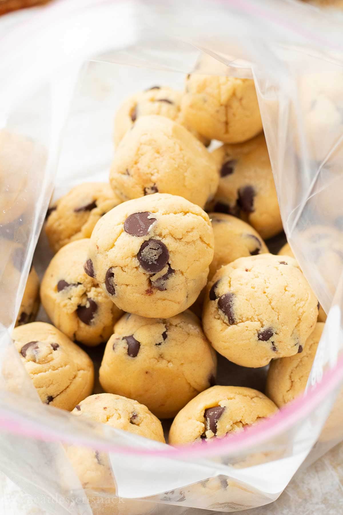 Raw cookie dough balls in freezer bag.
