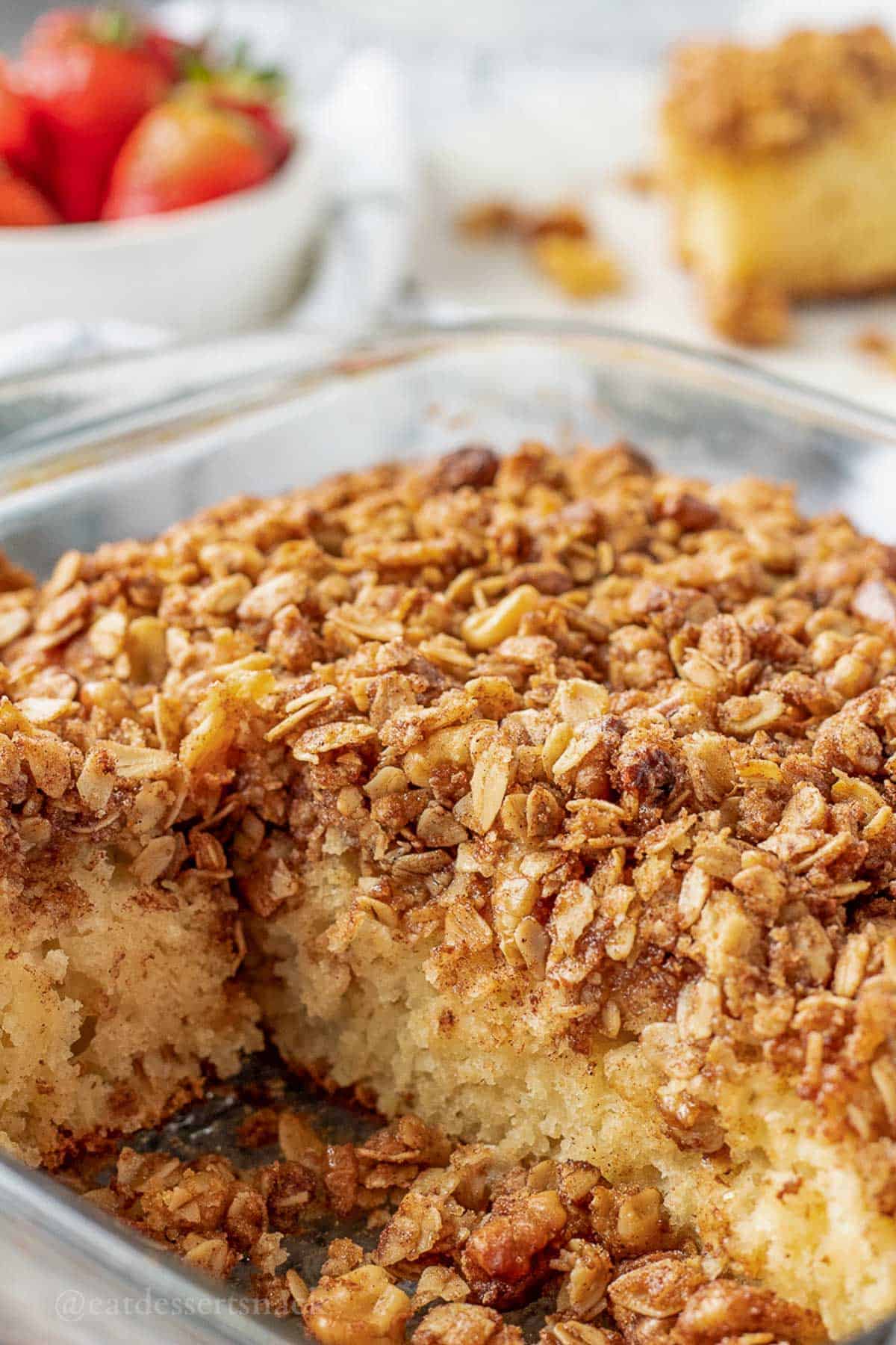 Baked coffee cake with slices removed in pan.