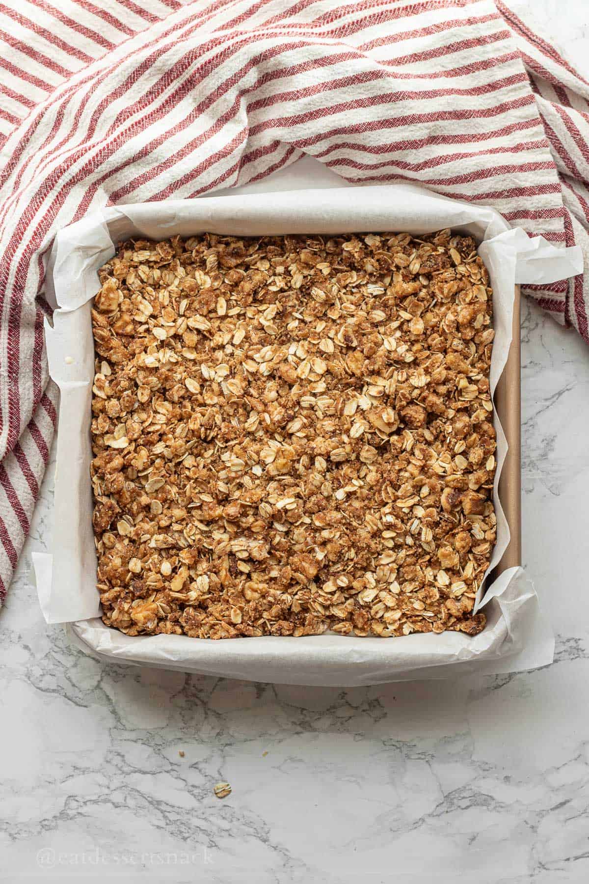 Streusel on raw cake batter in pan.