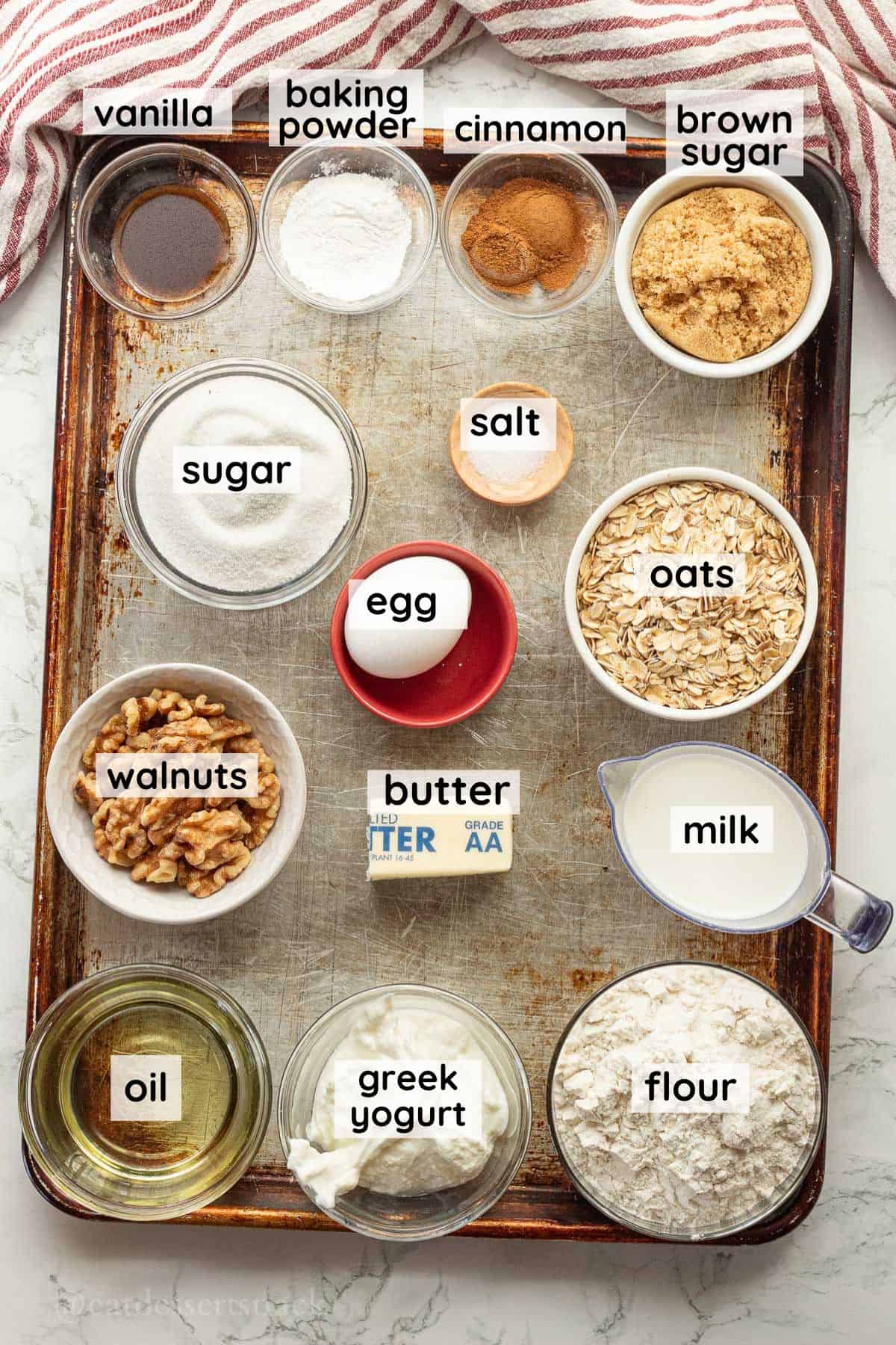 Labeled ingredients for cinnamon walnut coffee cake on metal pan in glass dishes.
