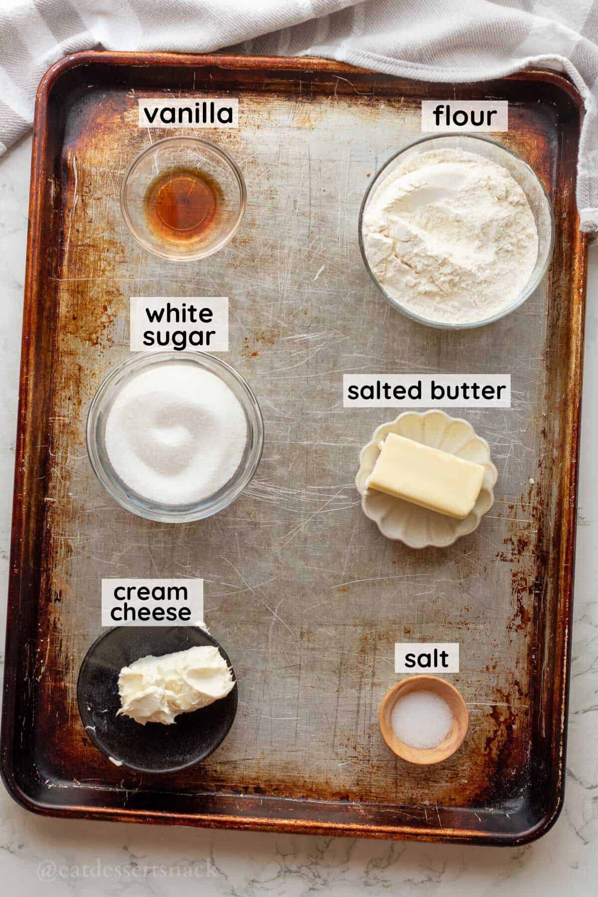 Labeled ingredients for edible sugar cookie dough in glass bowls.
