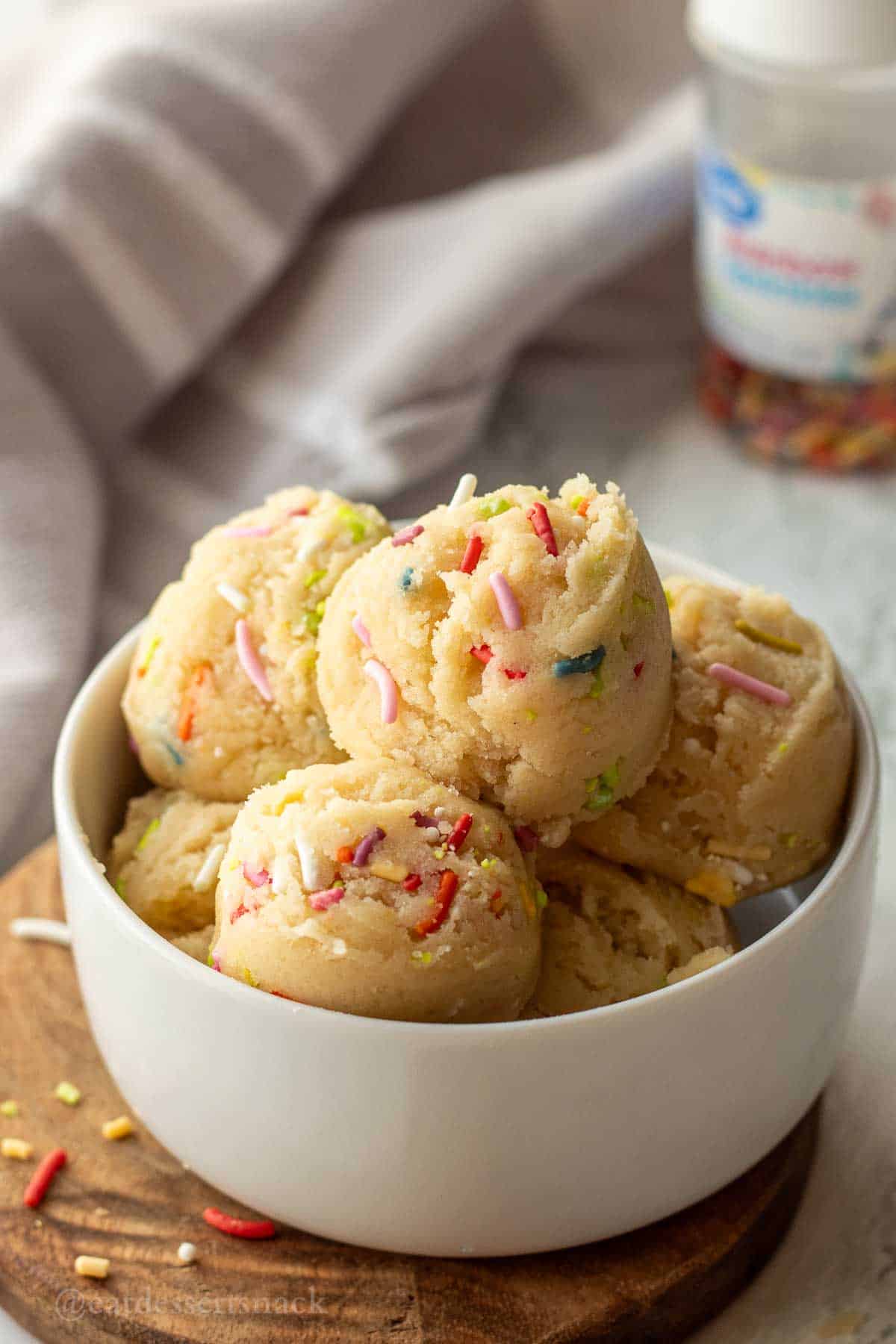 Scoops of edible sugar cookie dough with sprinkles.