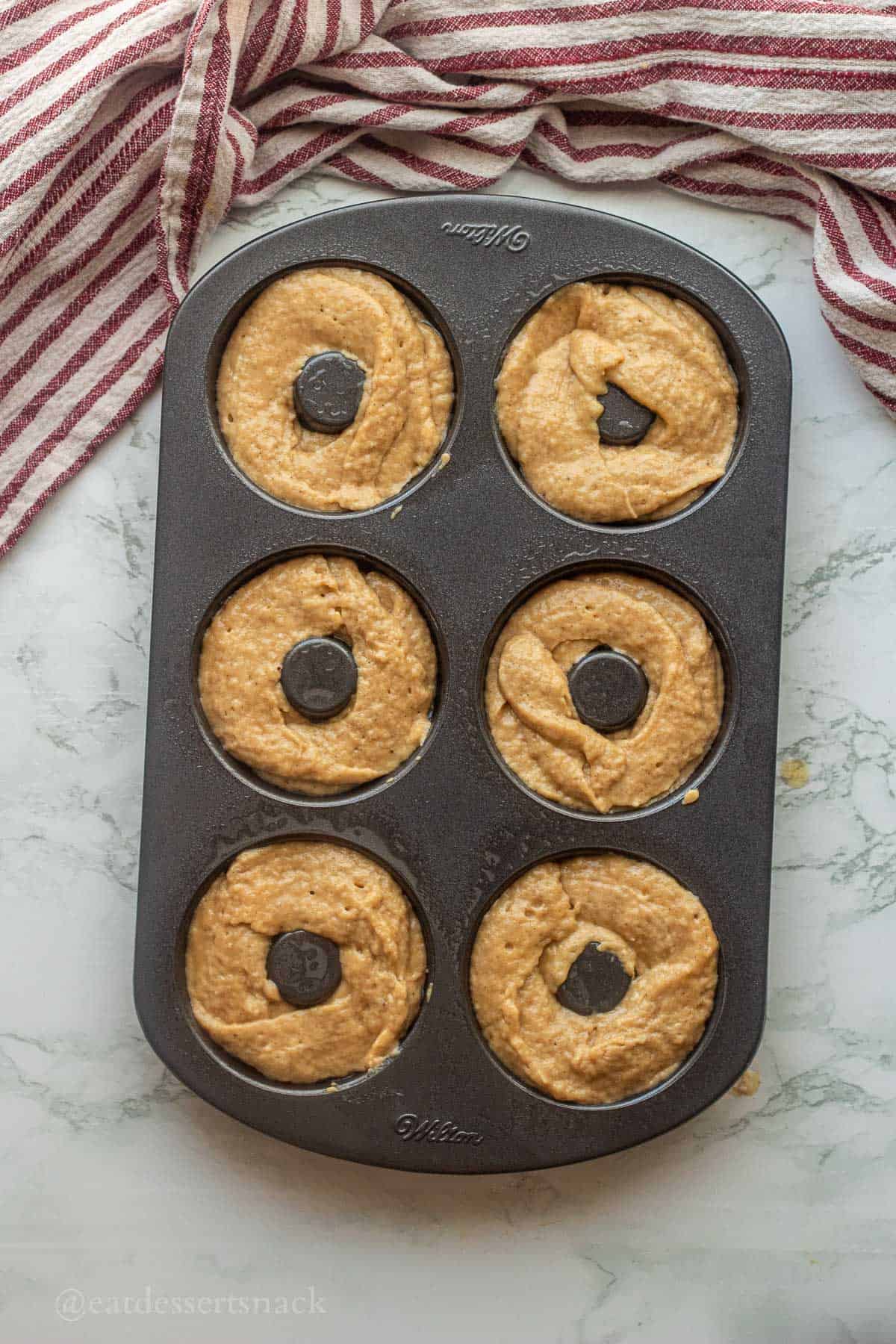 Raw apple cider donut batter in baking pan.