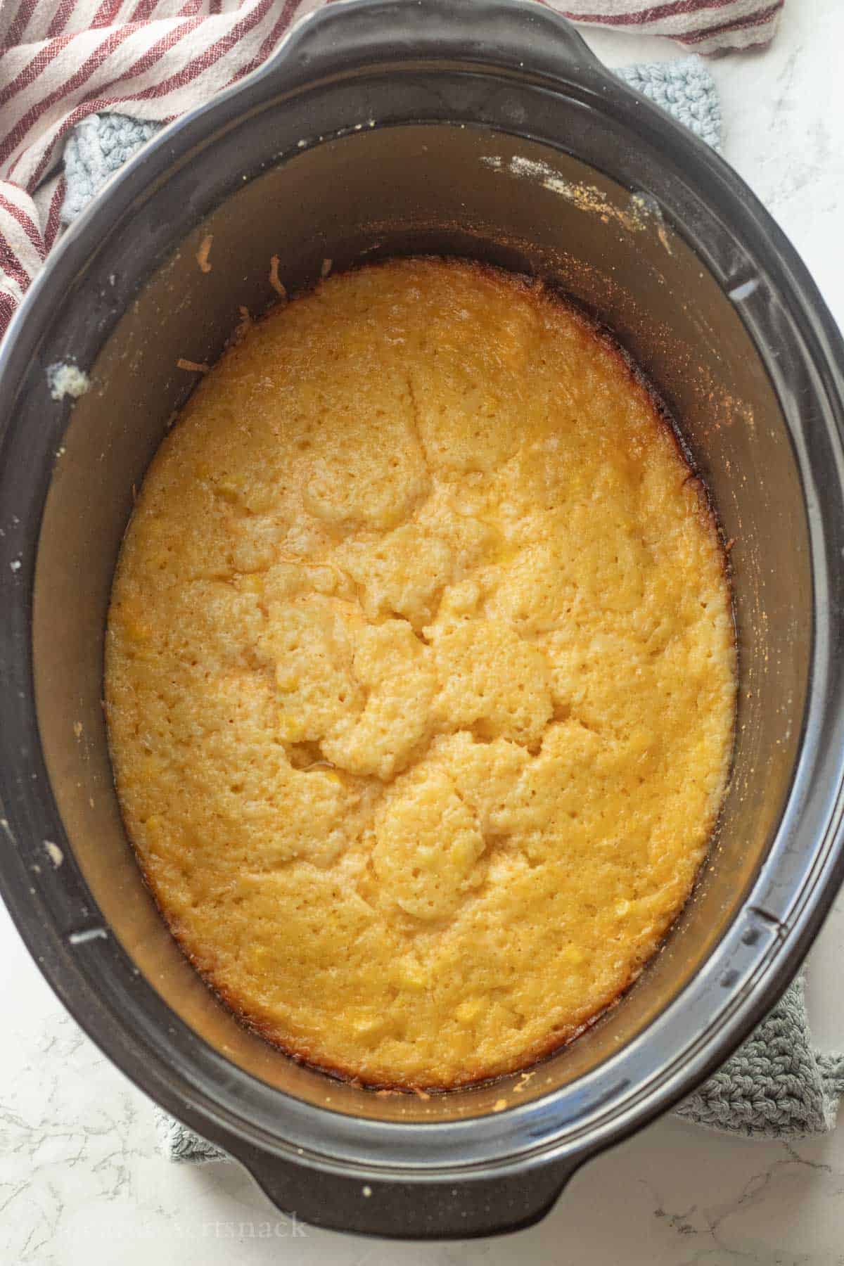 Cooked cornbread pudding in slow cooker.
