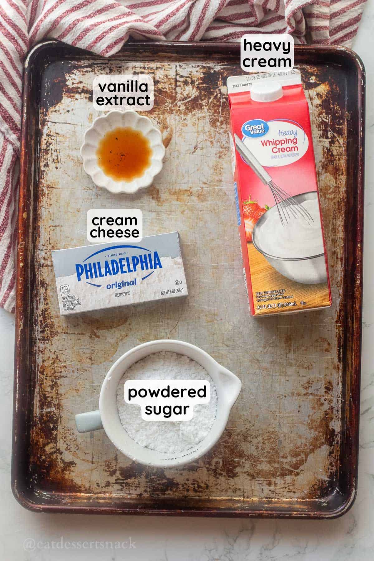 Labeled ingredients for cream cheese whipped cream on metal baking sheet.