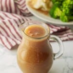 Glass pitcher of gravy.