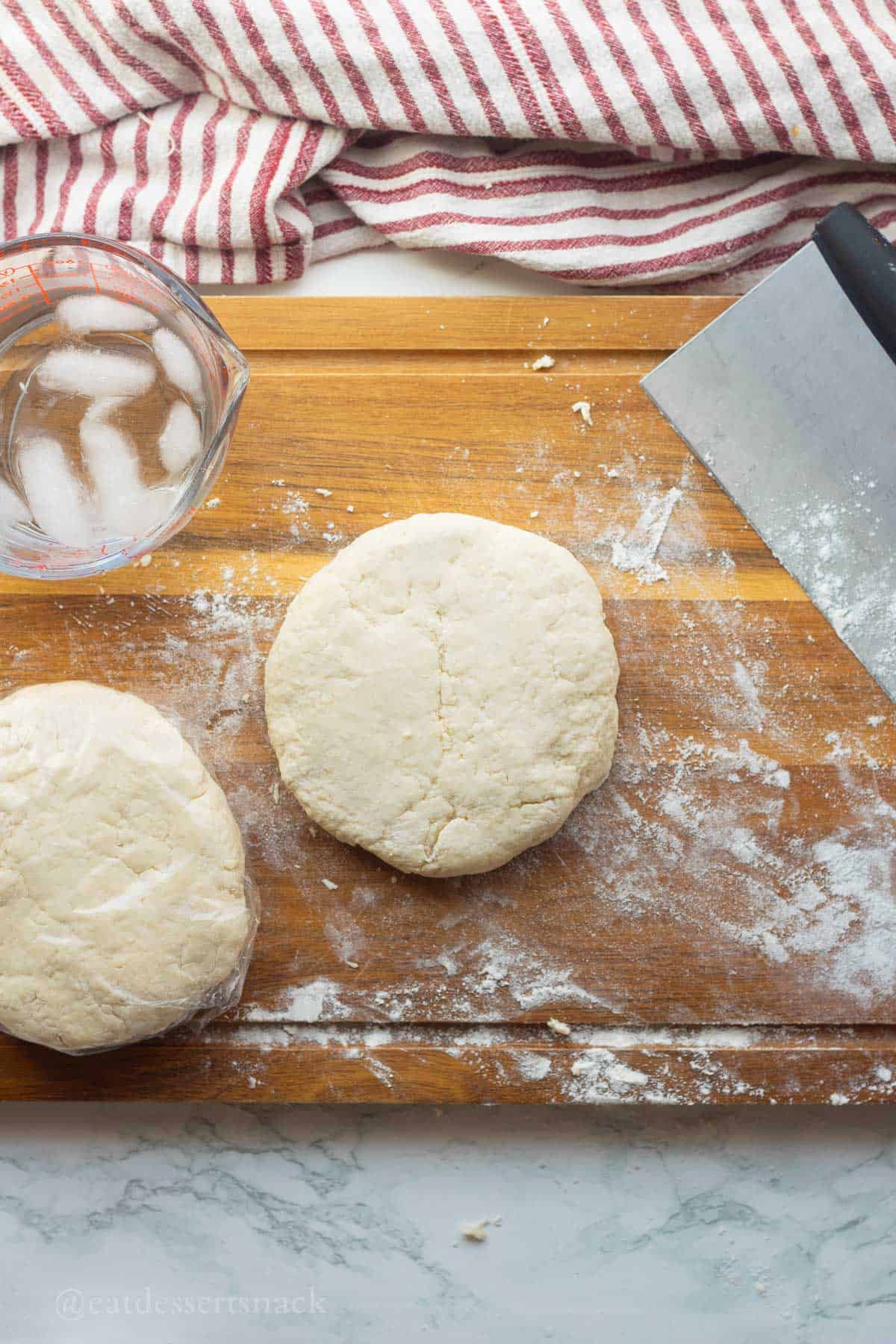 Dough shaped into disc on cutting board.