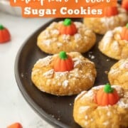 Baked pumpkin sugar cookies on plate.