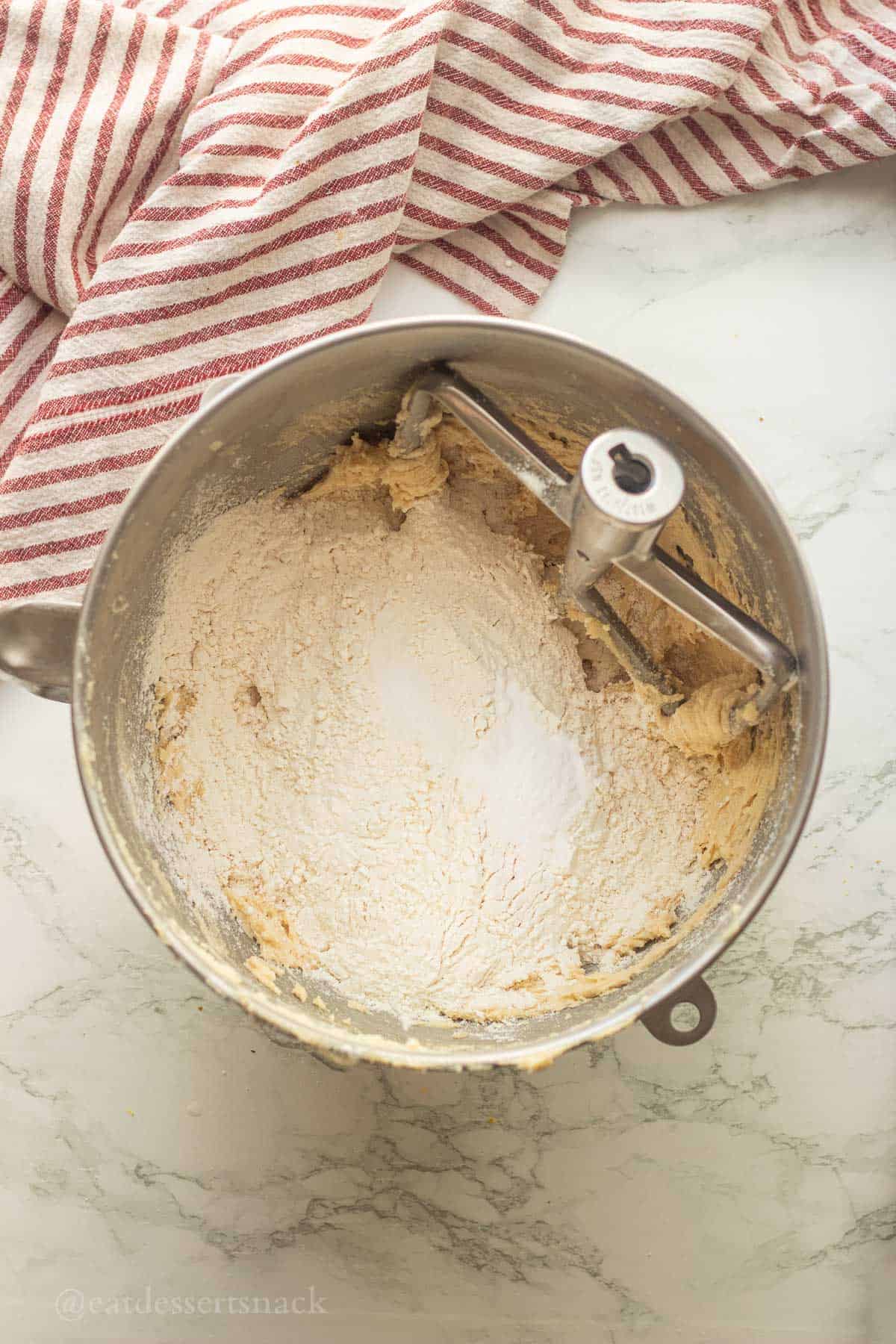 Flour, salt, and baking soda in mixing bowl of cookie dough.