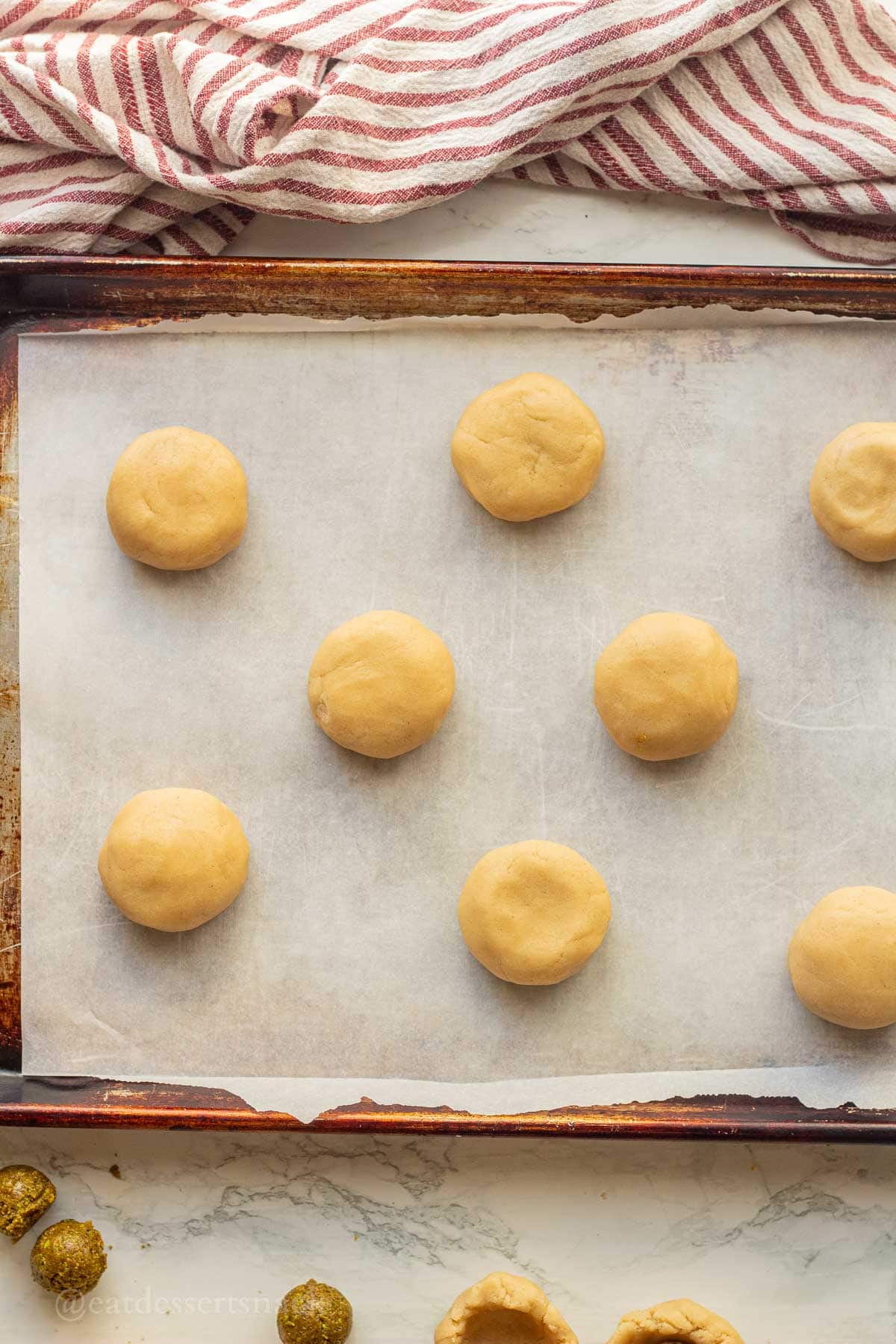 Raw baklava cookies on baking pan.