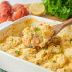 Spoonful of seafood pot pie in pan.