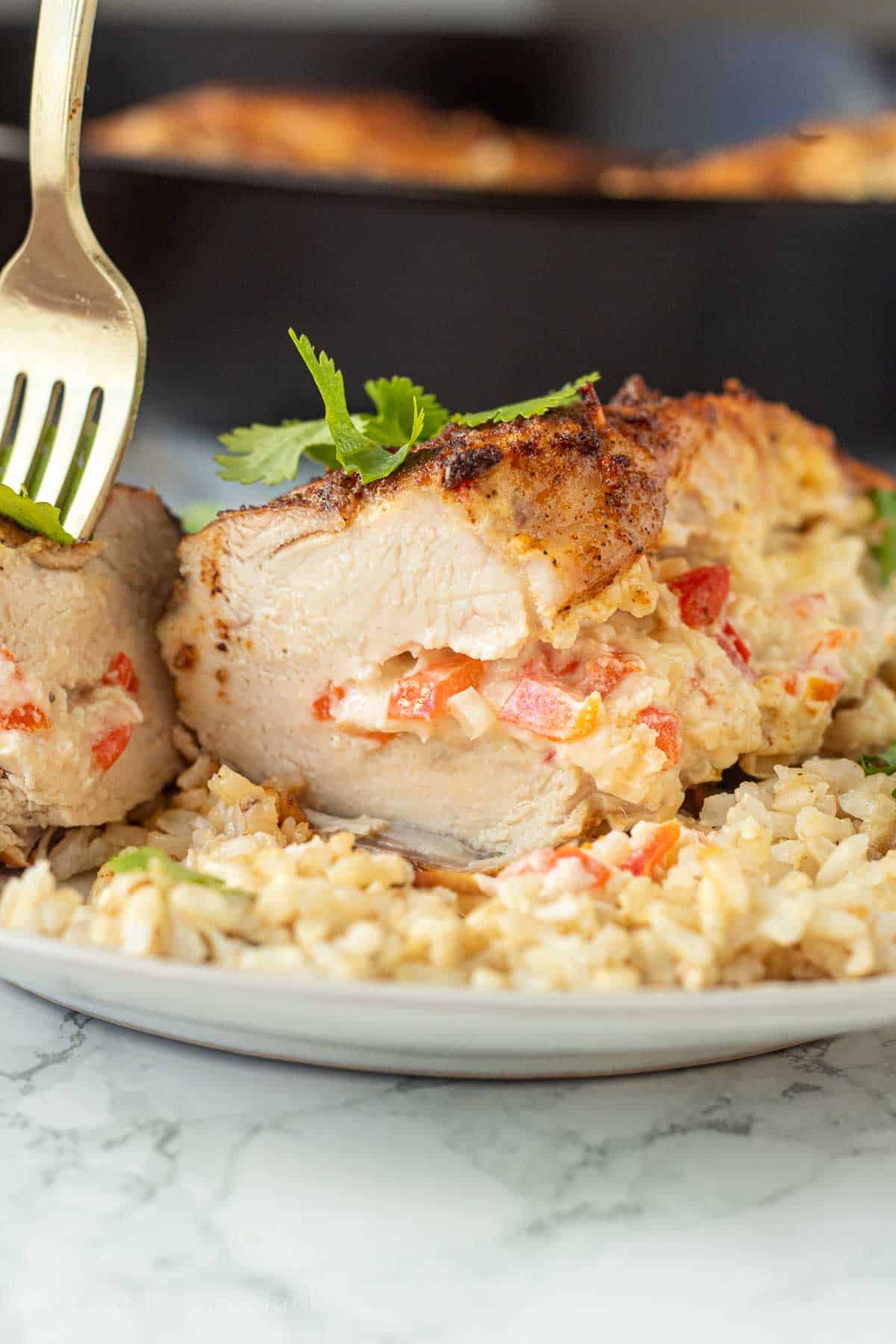 Sliced stuffed pepperjack chicken cooked over bed of rice.