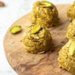 Pistachio protein ball on wooden board.