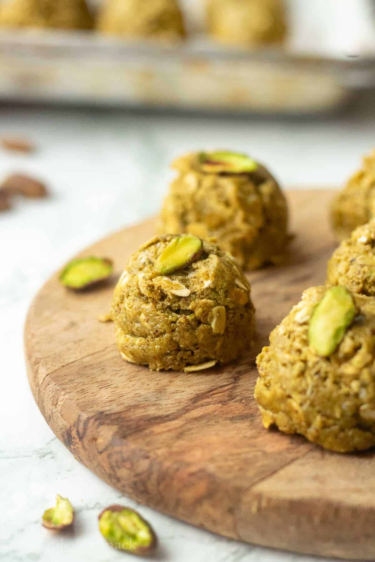 Pistachio protein ball on wooden board.