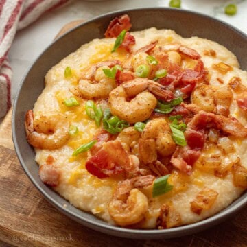 Plated cheesy shrimp and grits.