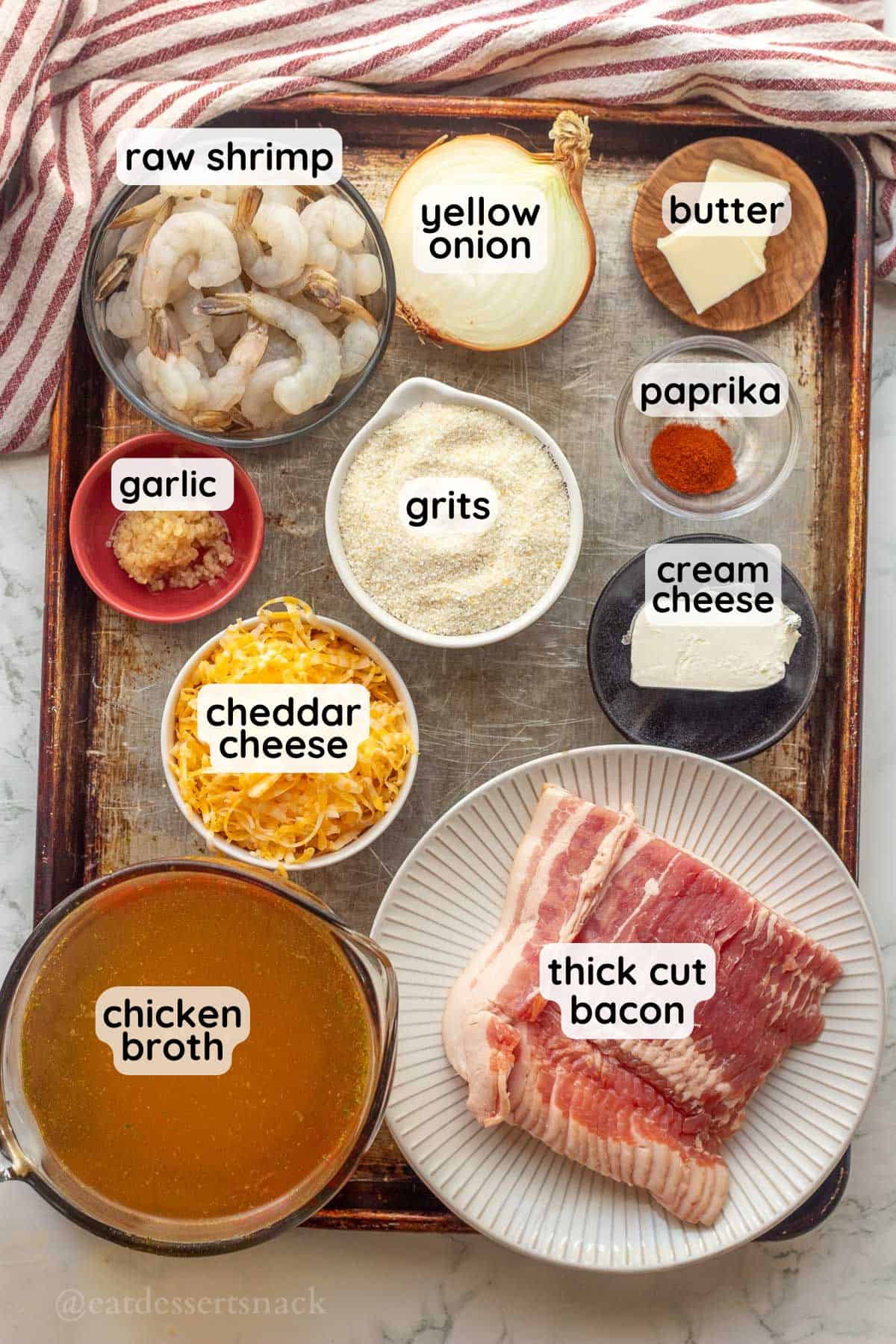 Labeled ingredients for shrimp and grits on metal baking pan.