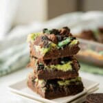 Stack of baked mint cheesecake brownies.
