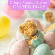 Half of a chocolate dipped peanut butter easter egg in egg carton.