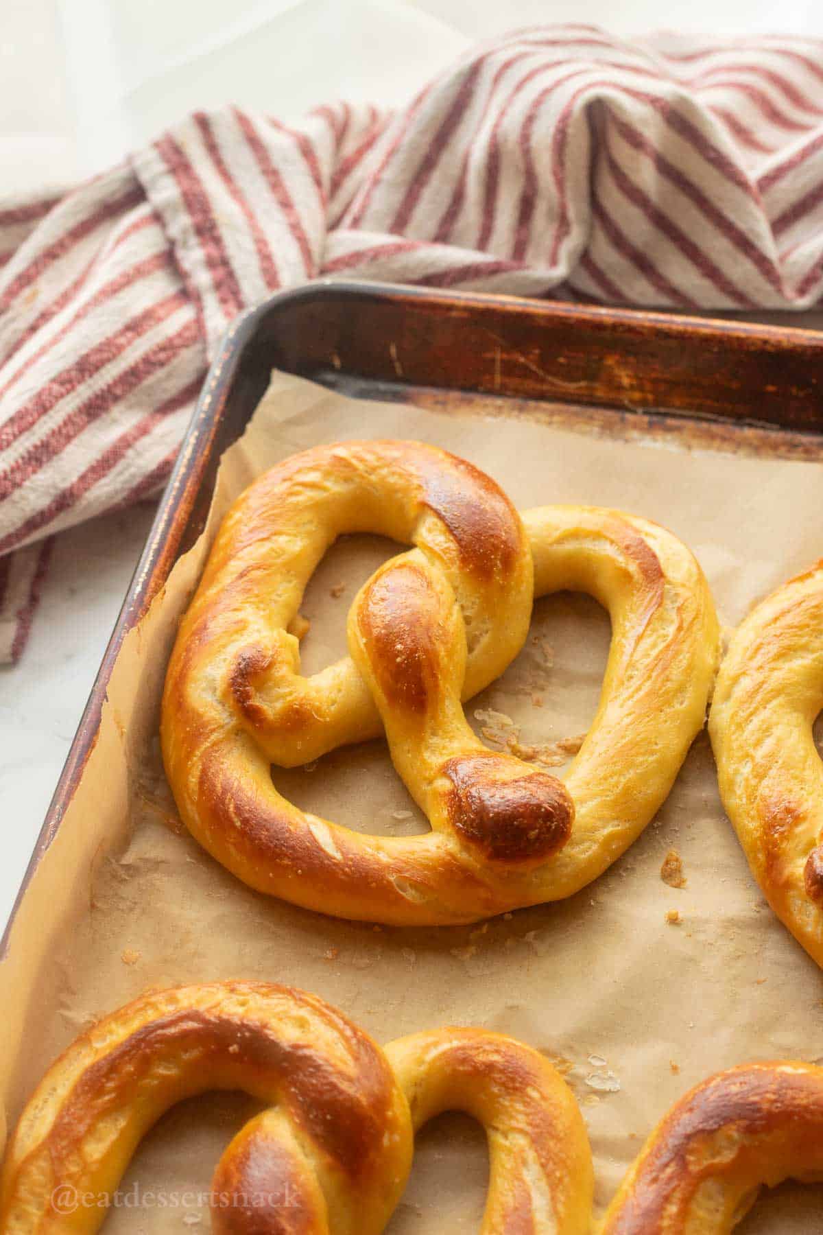 Baked pretzel on baking sheet.